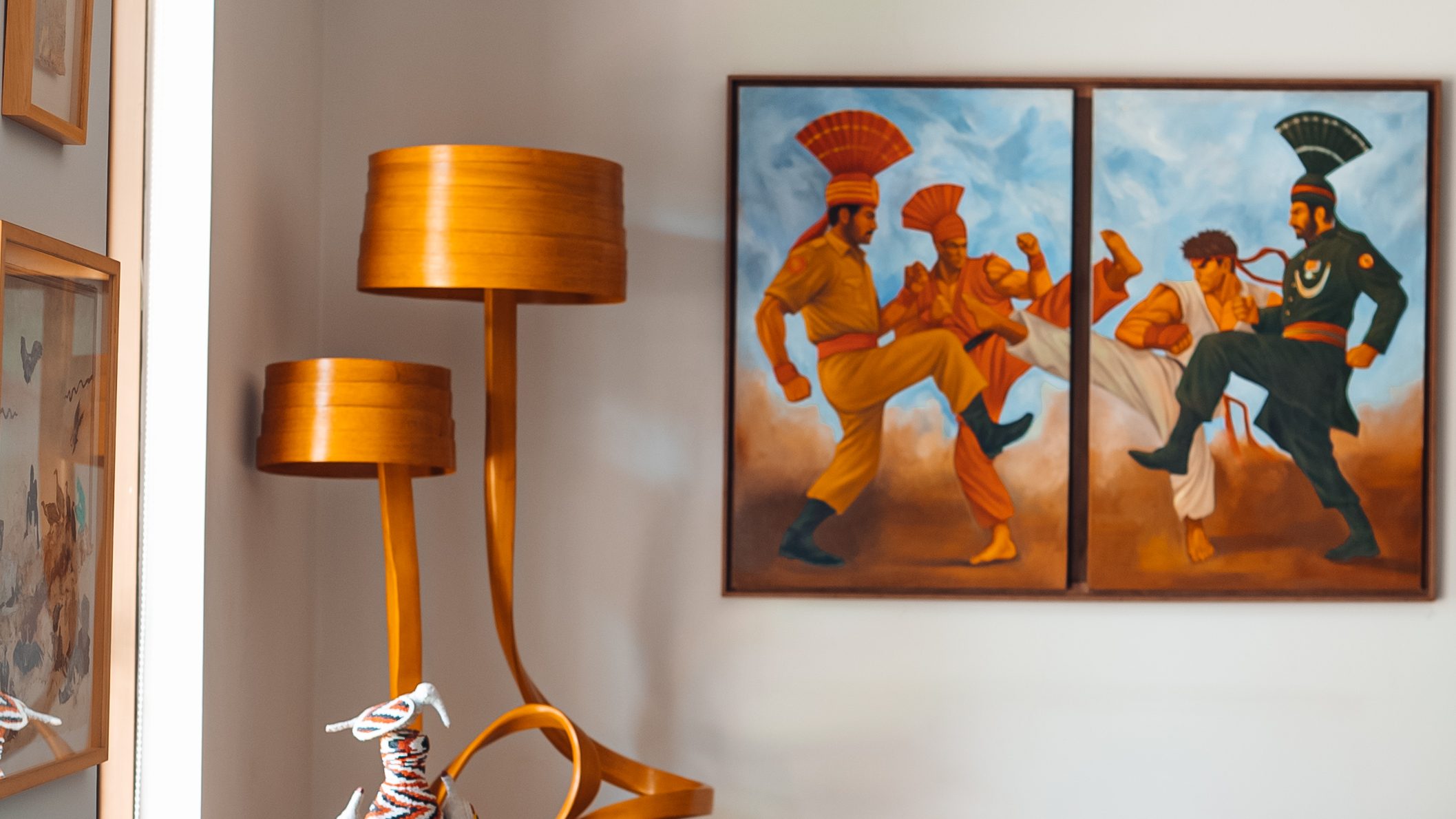 Bentwood floor lamps beside a painting of two dancers