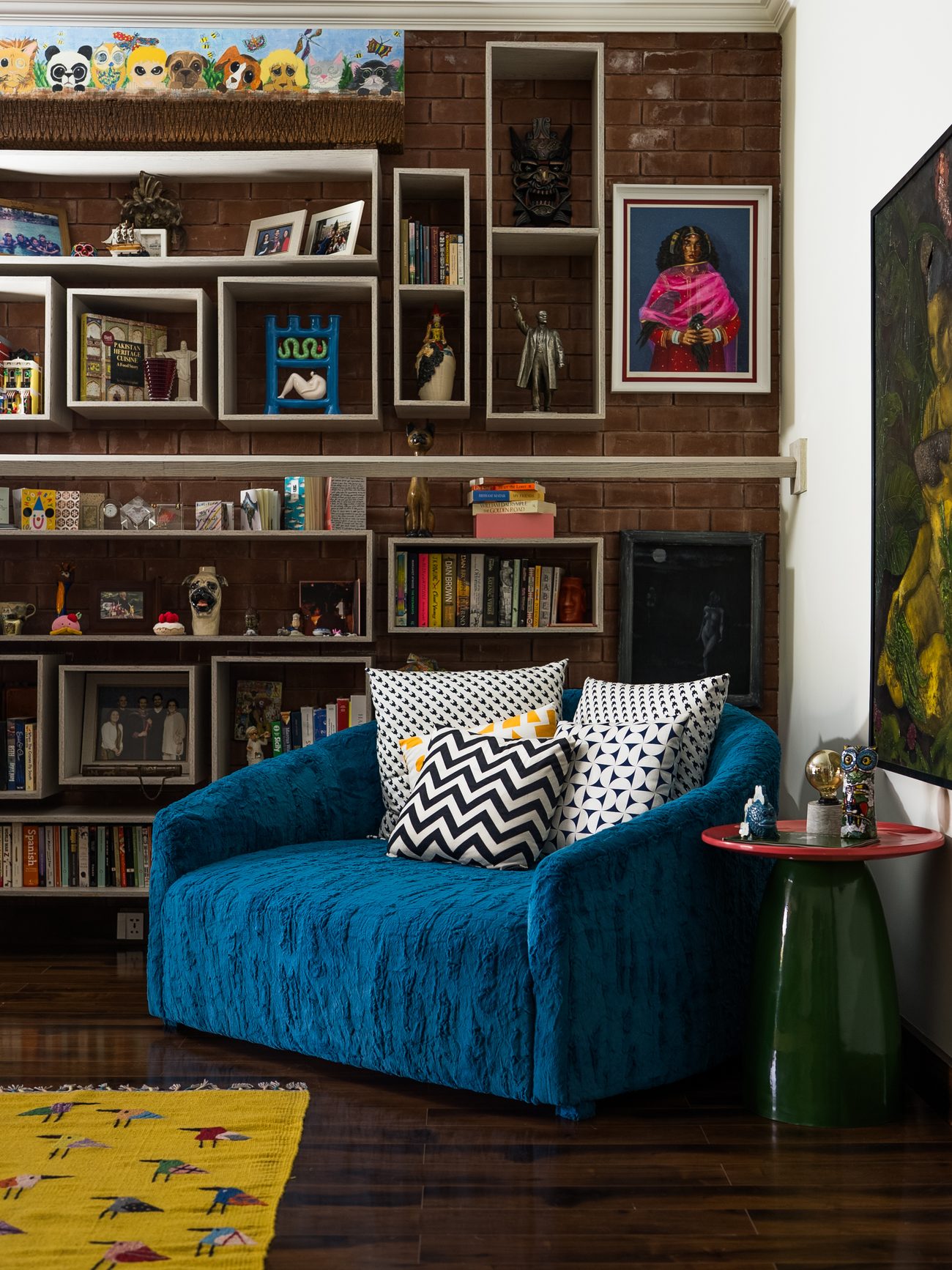 Bedroom built around a four-panel painted mural and a deep blue velvet bed