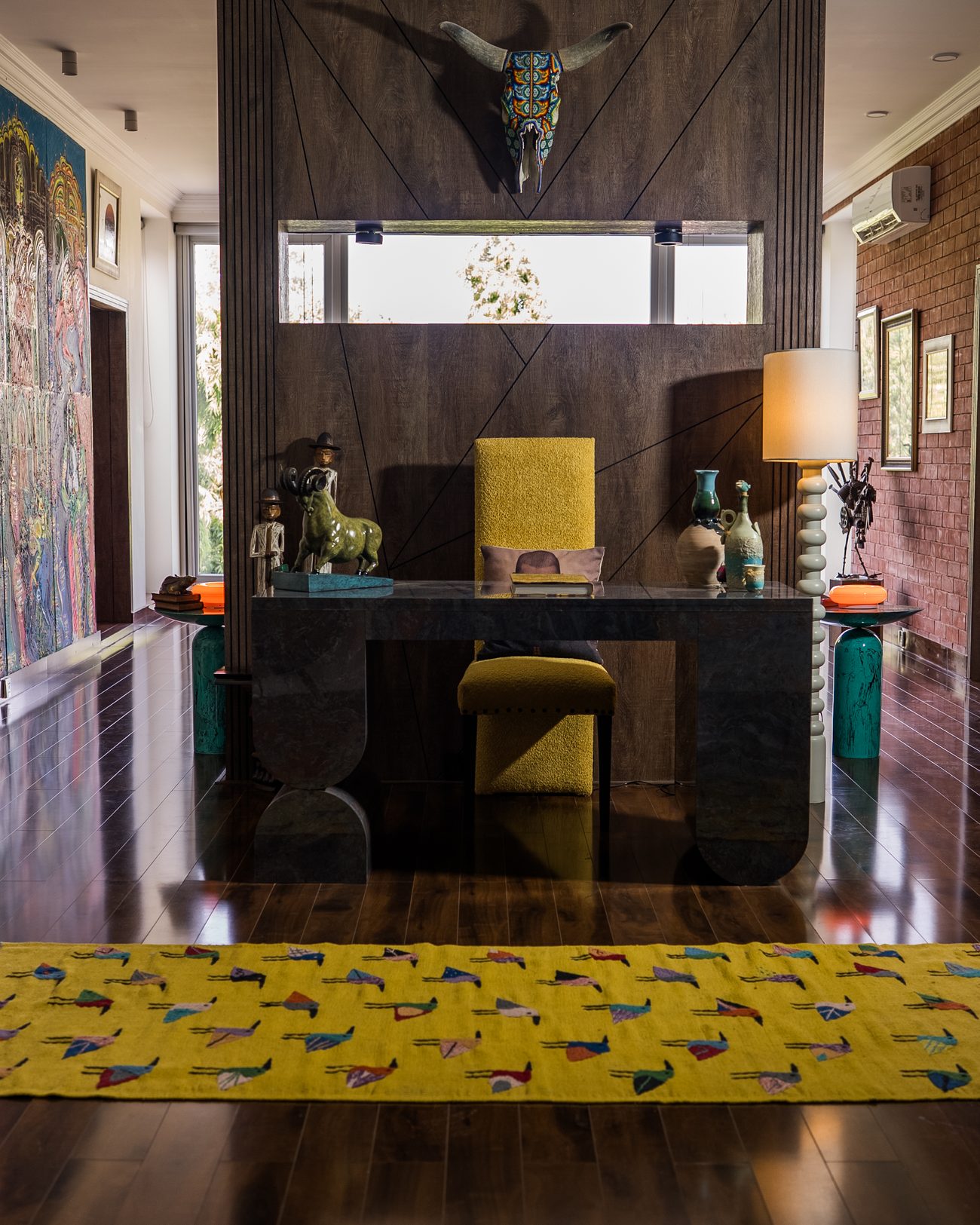Bedroom built around a four-panel painted mural and a deep blue velvet bed